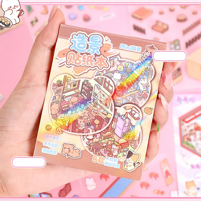 A hand holds a pink sticker book titled Mini Cottage 3D Sticker Book for Journaling and Crafts featuring various miniature sc