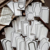 A collection of vintage scrapbooking paper sheets in white and gray tones for journaling and crafts.
