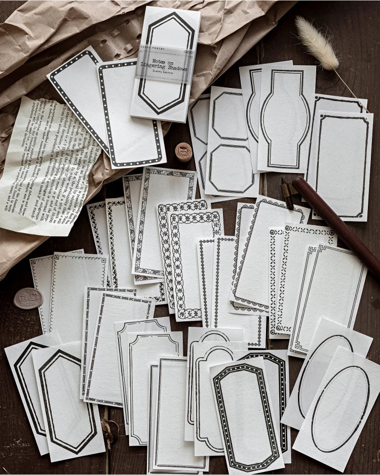 A collection of vintage scrapbooking paper sheets in white and gray tones for journaling and crafts.