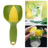 A green manual citrus juicer tool is shown with a lemon being squeezed into a glass of juice.