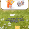 An orange bear-shaped automatic bubble gun with lights is shown next to a bottle of solution and several bubbles on green gra