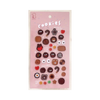 A sheet of pink stickers featuring various cookie-themed designs like chocolate chip cookies and gingerbread men.