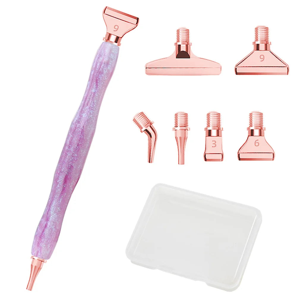 A set of pink resin diamond painting pens with interchangeable metal tips and multi-placers, including various sizes.