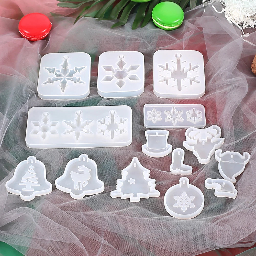 A collection of white silicone molds shaped like snowflakes and Christmas trees for jewelry and craft projects.