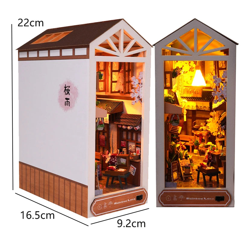 A wooden book nook kit featuring a miniature house facade with interior details and LED lights.