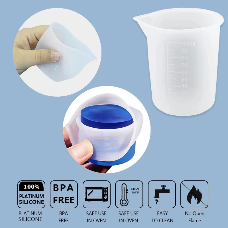 A white silicone resin mixing tool kit shown with a measuring cup and stir sticks, demonstrating its use.
