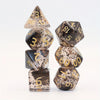 A set of crystal style polyhedral dice, including a triangular die and several hexagonal dice, displayed on a white backgroun