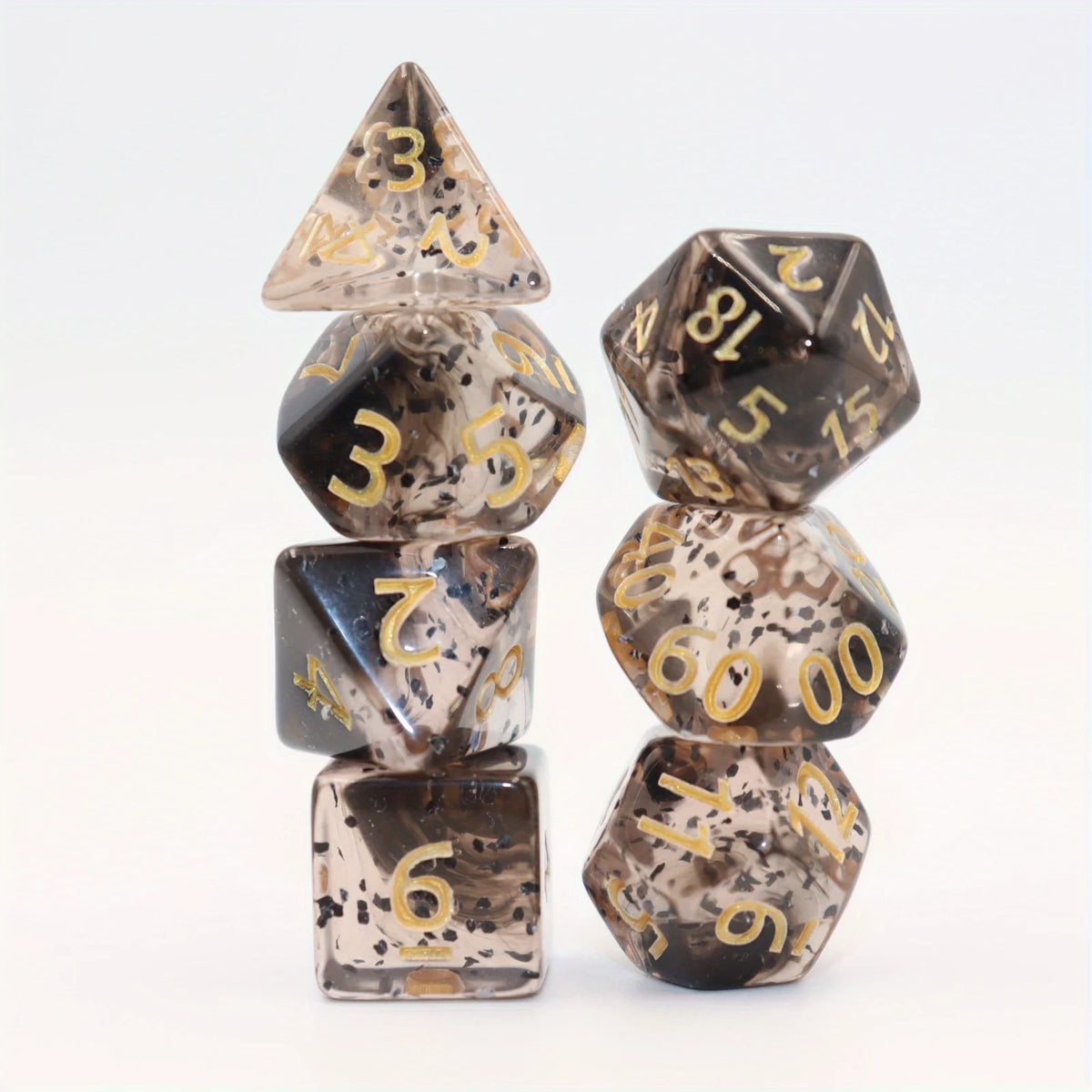 A set of crystal style polyhedral dice, including a triangular die and several hexagonal dice, displayed on a white backgroun