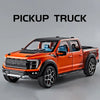 Orange pickup truck diecast model in a black cab with light and sound effects.