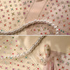 Close-up of sparkling 5D diamond nail art stickers arranged on a pink background.