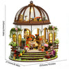 A detailed miniature dollhouse kit featuring a dome roof, furniture, and warm lighting display.