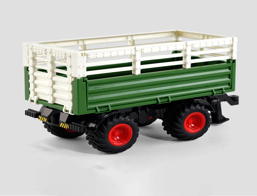 A green and white remote control tractor with a trailer is shown on a white surface.