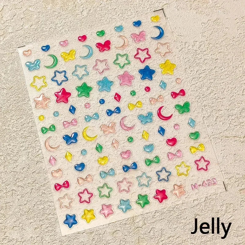 A sheet of colorful jelly nail art stickers featuring various shapes and colors like stars moons and hearts.
