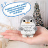 A hand holds a handmade crochet penguin doll with a positive message card, encouraging the viewer to believe in themselves.