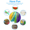 A collection of multi-colored PLA filament pens and 3D printed objects including a watermelon slice, a plane, glasses, and sm