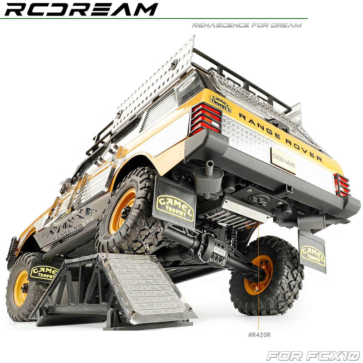 A scale model RC Range Rover vehicle with mud flaps, fuel tank, and exhaust components for an FCX10 kit.