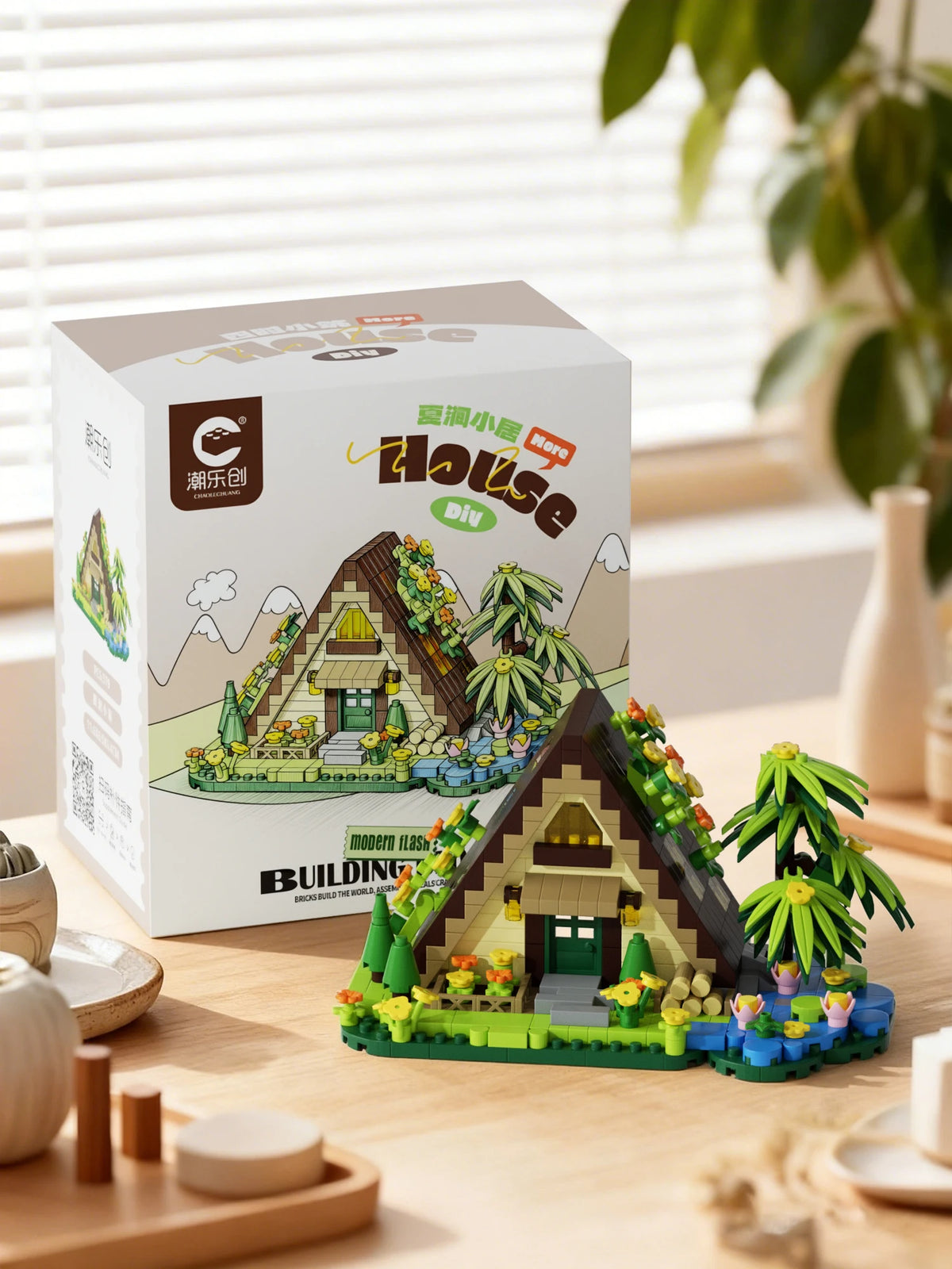 A box of Forest Cabin Micro Building Blocks set featuring a detailed wooden house with greenery and landscape elements.