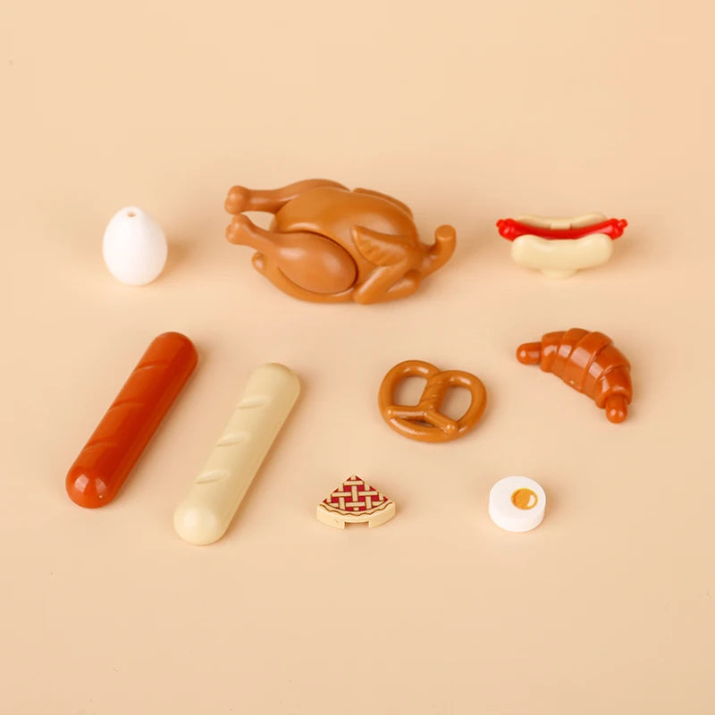 A collection of mini food building blocks including a turkey, sausage, bread, and various other food shapes.