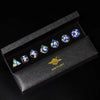 A set of six blue and purple resin polyhedral dice displayed inside a black box labeled Mini Planet.