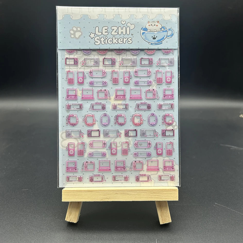 A sheet of Le Zhi stickers featuring various pink and purple decorative items like cameras, phones, and other cute accessorie
