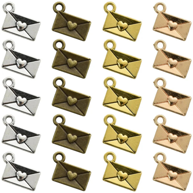 A collection of 40 vintage envelope charms in gold and rose gold finishes for jewelry making.