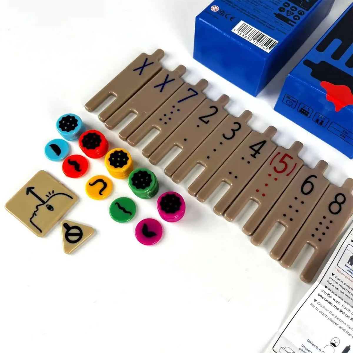 A collection of wooden strategy game pieces and a blue box for a family game night.