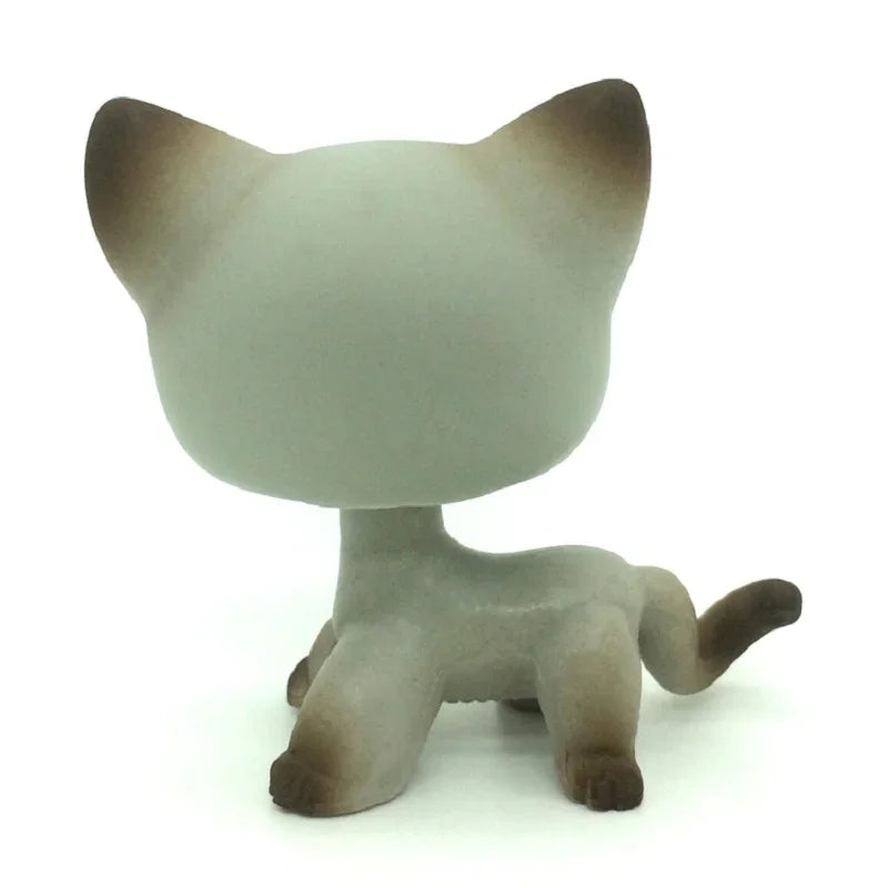 A small, gray and brown standing dog figure resembling a Littlest Pet Shop style toy.
