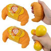 An orange squishy croissant stress relief toy is shown in various forms, including a hand-held version and a standalone yello