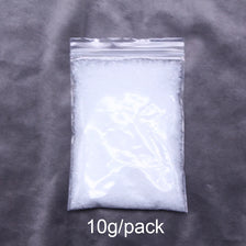 A clear plastic bag containing 10 grams of white artificial snow powder.