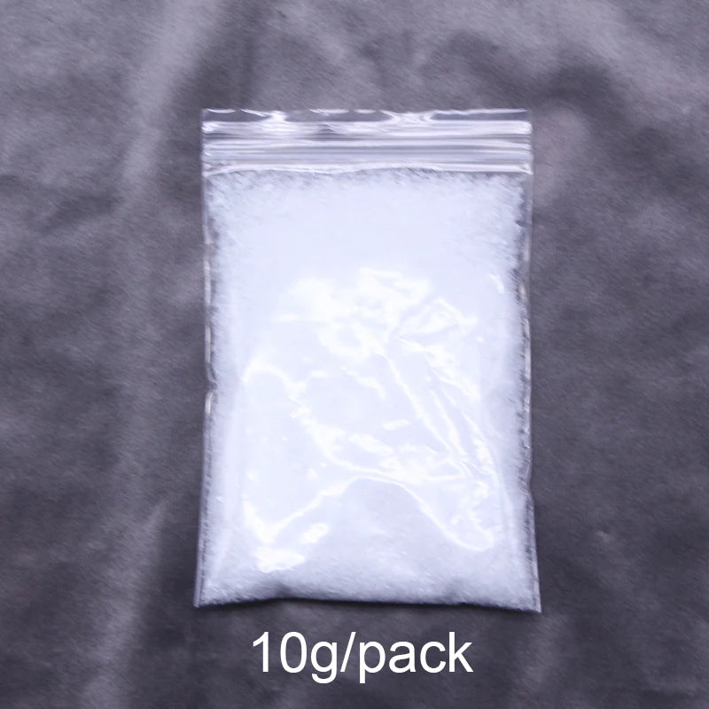 A clear plastic bag containing 10 grams of white artificial snow powder.