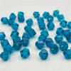 A collection of faceted blue crystal glass beads in various sizes and shapes for jewelry making