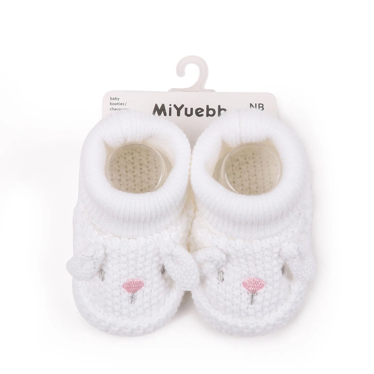 Pair of white knitted baby booties with a cute face design