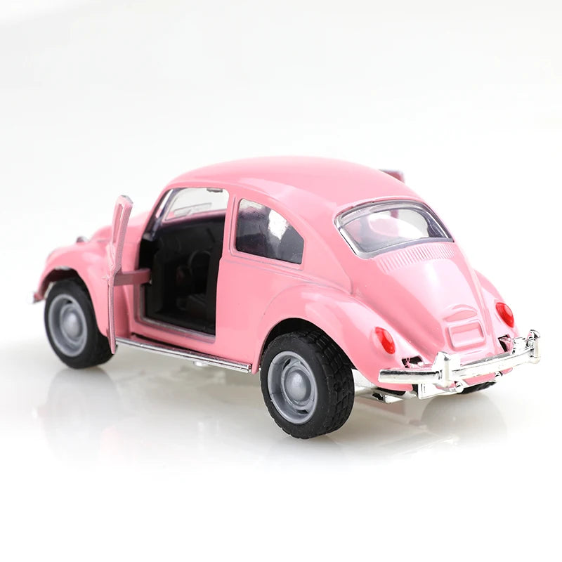 A pink 1:38 die-cast model of a classic Beetle car.