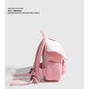 A pink mini backpack with a white mushroom print detail shown against a light gray background.