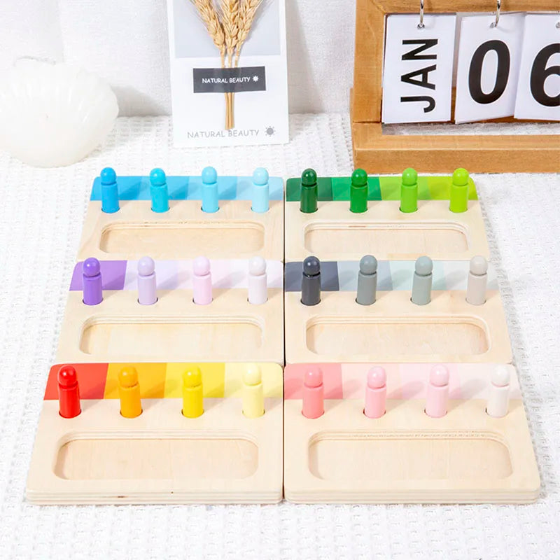 Wooden color matching Montessori toy with 24 color blocks arranged in wooden trays.