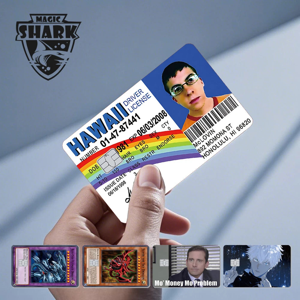 A hand holds a Hawaii driver license card with an anime theme, featuring characters like Mo' Money and Mo' Problem.