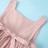 A light pink summer cotton linen jumper dress for a toddler girl, shown flat lay against a light blue background.