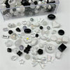 A collection of mixed clear, black, and white acrylic bow and flower beads for jewelry making.