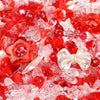 A close-up view of mixed red and pink acrylic loose beads for jewelry making.