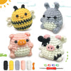 A beginner crochet kit for amigurumi animals featuring a bee, a rabbit, and a pig in various yarn colors.