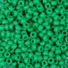 A pile of small, bright green, round pony beads for jewelry making and craft projects.