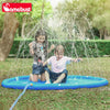 Two children playing with an inflatable blue mat that sprays water outdoors.