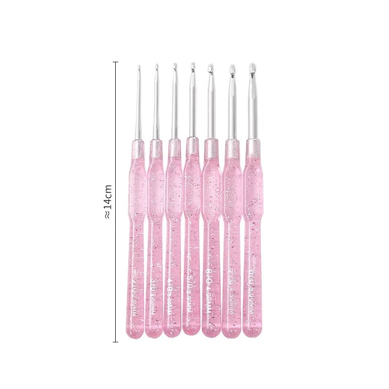 A set of seven pink aluminum crochet hooks with color-coded handles displayed vertically.