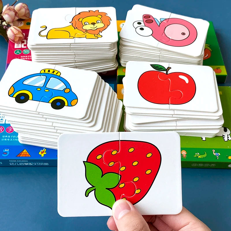 A hand holds a stack of colorful animal matching cards, including a lion, a pig, and a strawberry.