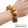 A hand is wearing a bracelet made of natural wooden spacer beads for jewelry making.