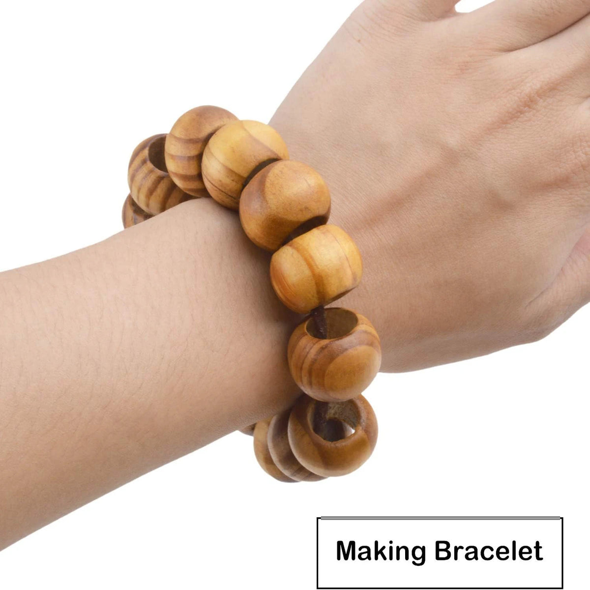 A hand is wearing a bracelet made of natural wooden spacer beads for jewelry making.