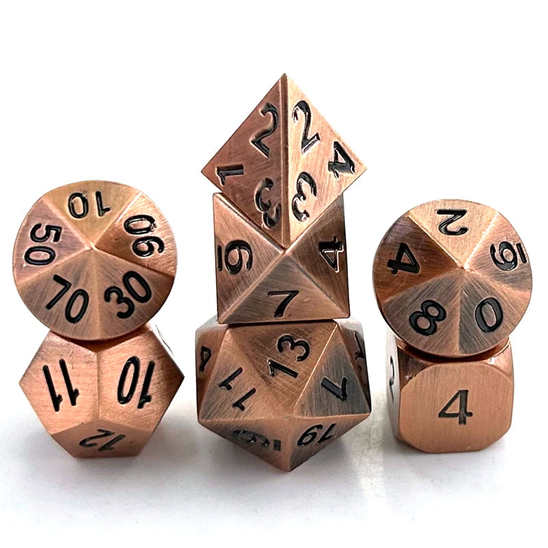 A set of premium metal polyhedral dice with a multicolor gold finish arranged on a white surface.