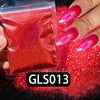A hand displays a vibrant red holographic nail glitter product with fine sparkle dust on a dark background.