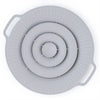 A silicone spill stopper lid with concentric rings and perforated edges for pots and pans.