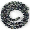 A strand of dark green and black jasper and turquoise beads for jewelry making